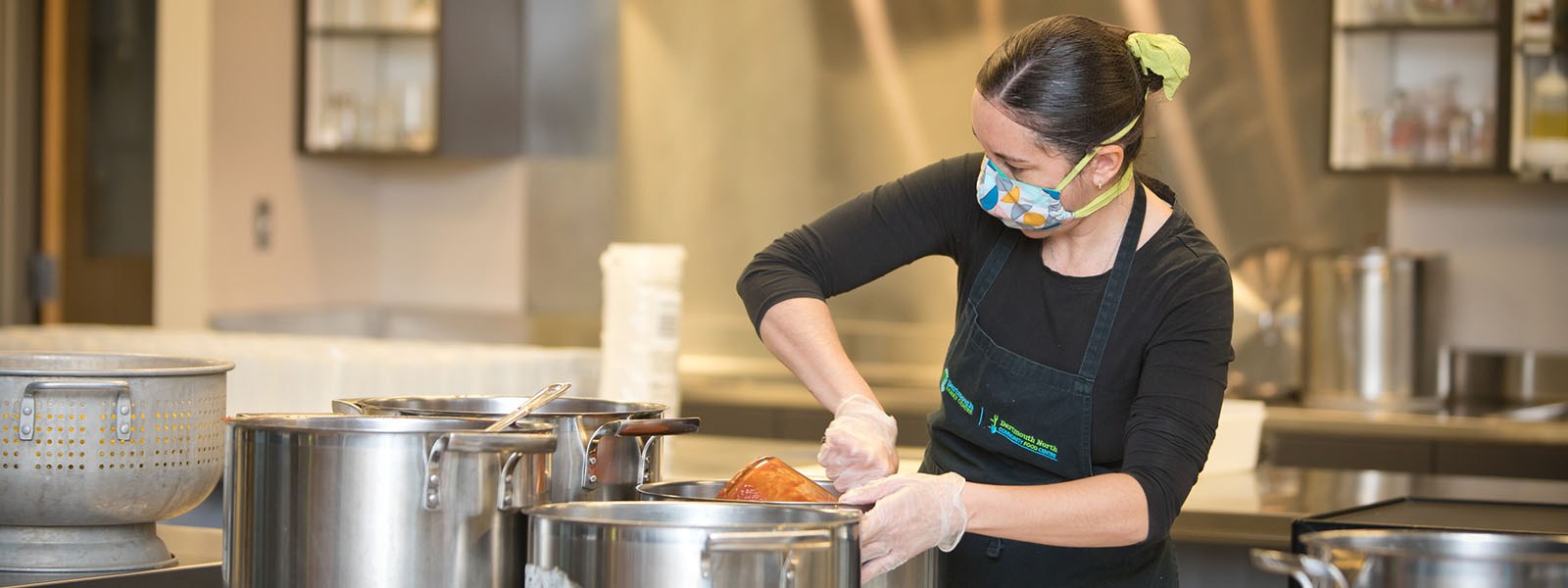 Image of female volunteer preparing food at the North Grove Community Centre. Image of female volunteer preparing food at the North Grove Community Centre.